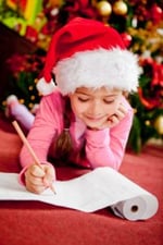 11467024 - girl writing a christmas wish list for santa