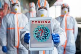 Workers in Hazmat suits sharing info on coronavirus