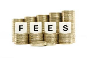 A stack of coins with the word "FEES" in the foreground