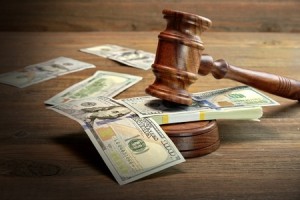 Photo of a gavel on a stack of paper money